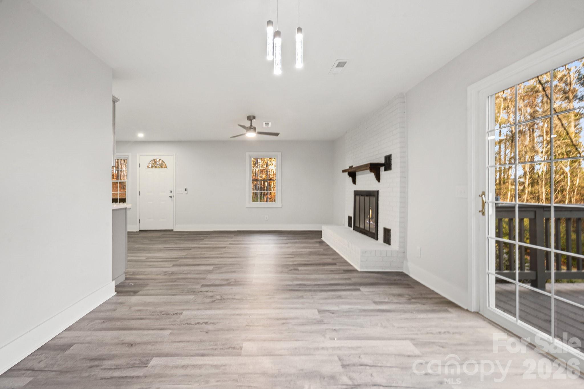 28 Robert Tyson Road Wadesboro, NC 28170 - Photo 6 of 23 an empty room with wooden floor and windows