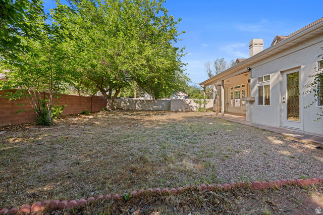 20 Valley Road Leeds, UT 84746 - Photo 37 of 57 Spacious backyard with mature shade trees, a covered patio, and a stucco exterior