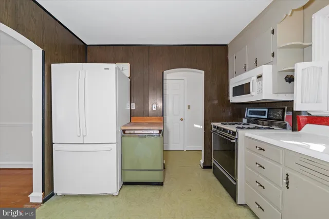 a kitchen with cabinets and stainless steel appliances