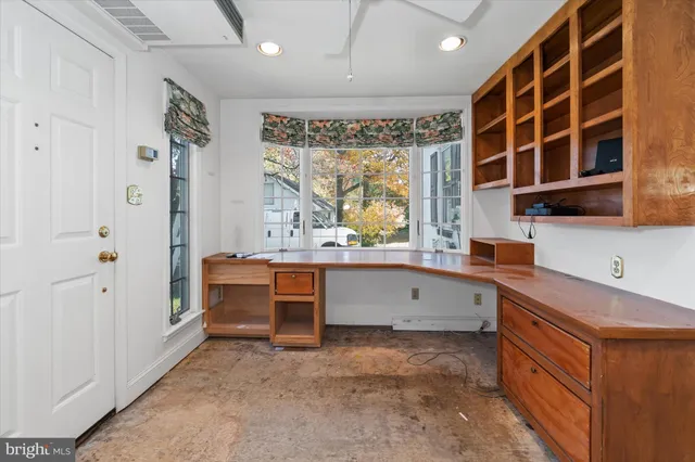 a large white kitchen with a large window