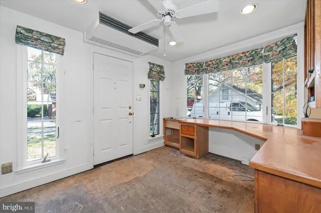 a large white kitchen with granite countertop a large window
