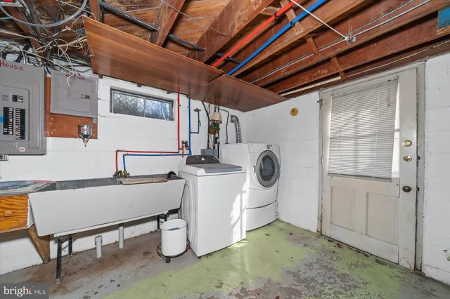 a view of a storage & utility room with sink dryer and washer