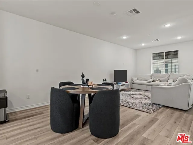 a living room with furniture a wooden floor and sink