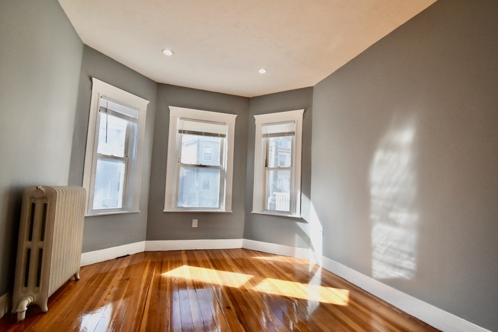 21 Treadway Road, Unit 2 Boston, MA 02125 - Photo 8 of 21 a view of an empty room with wooden floor and a window