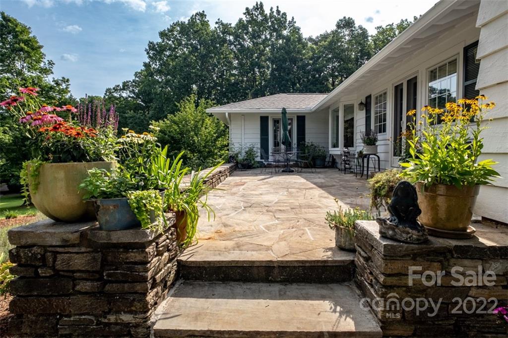 252 Hillbrook Road Tryon, NC 28782 - Photo 12 of 48 a view of a house with sitting area and potted plants