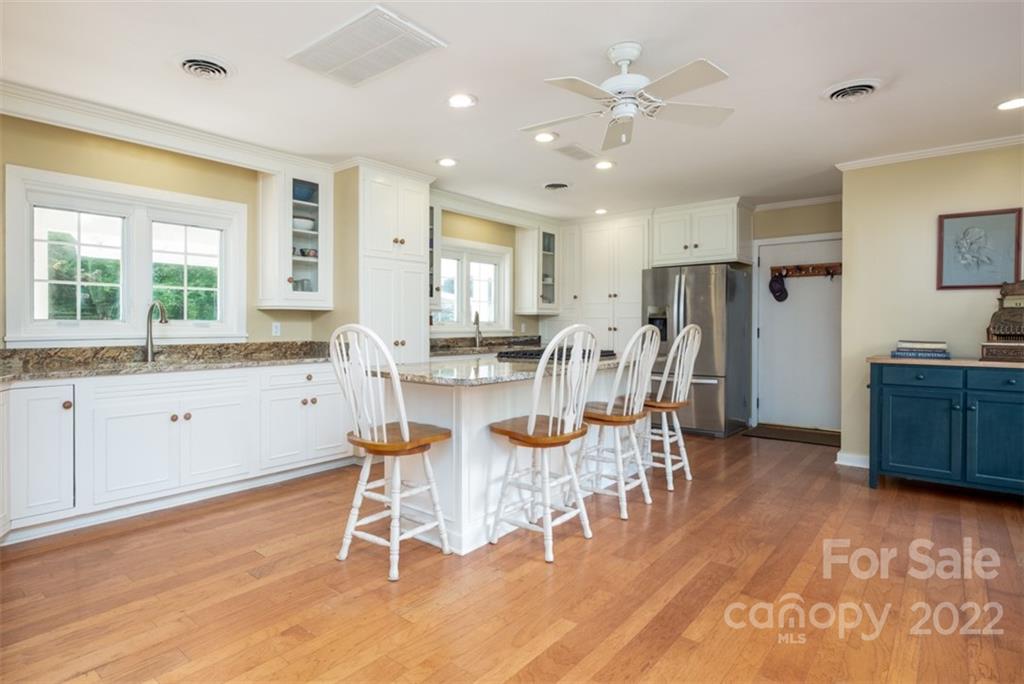 252 Hillbrook Road Tryon, NC 28782 - Photo 18 of 48 a kitchen with stainless steel appliances kitchen island granite countertop a dining table chairs and granite counter tops
