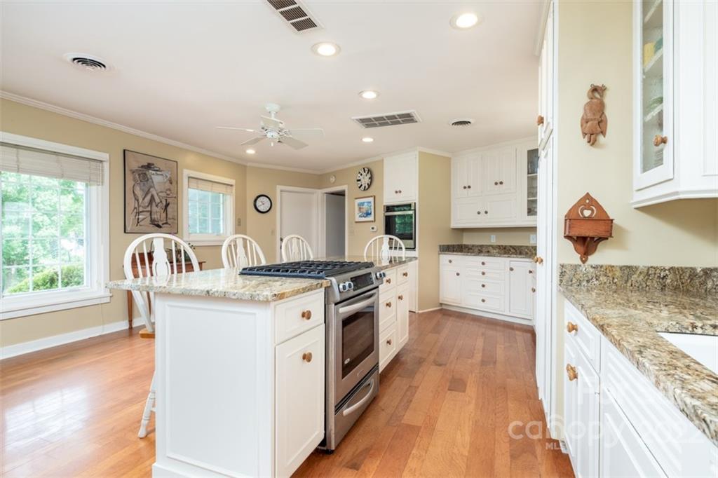 252 Hillbrook Road Tryon, NC 28782 - Photo 20 of 48 a kitchen with granite countertop a sink stove and cabinets
