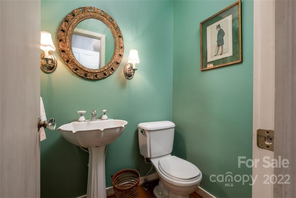 252 Hillbrook Road Tryon, NC 28782 - Photo 29 of 48 a bathroom with a toilet sink and mirror