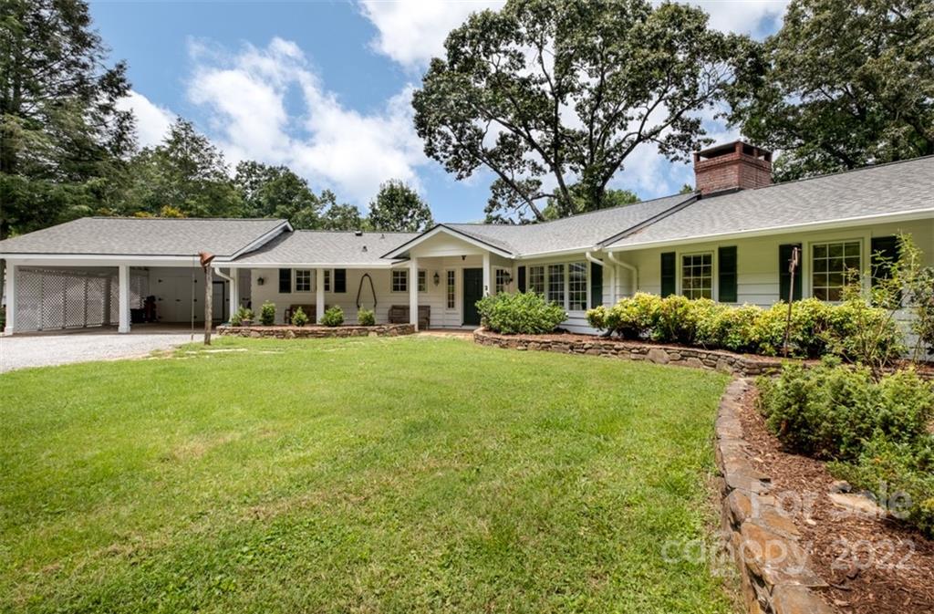 252 Hillbrook Road Tryon, NC 28782 - Photo 3 of 48 a front view of a house with a yard table and chairs