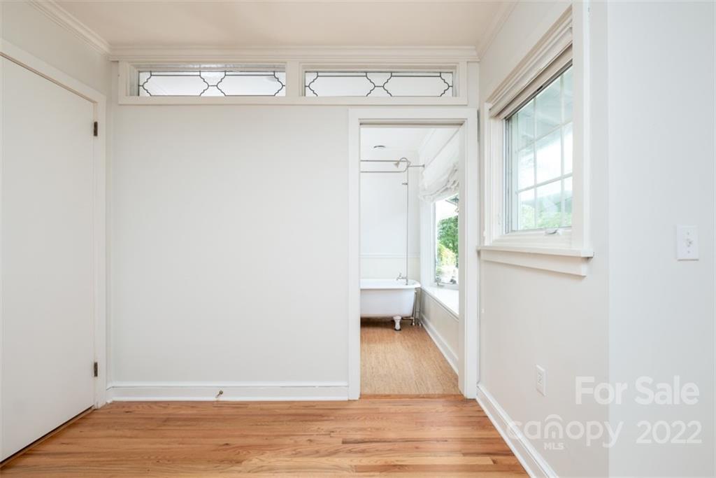 252 Hillbrook Road Tryon, NC 28782 - Photo 32 of 48 a view of an empty room with a window and wooden floor