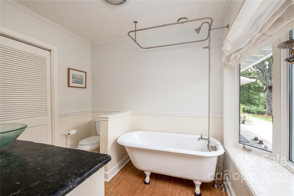252 Hillbrook Road Tryon, NC 28782 - Photo 33 of 48 a bathroom with a granite countertop sink and a bathtub