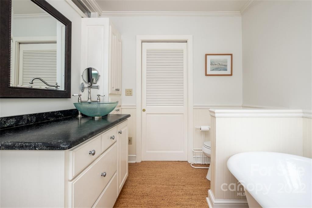 252 Hillbrook Road Tryon, NC 28782 - Photo 34 of 48 a bathroom with a granite countertop sink and a mirror