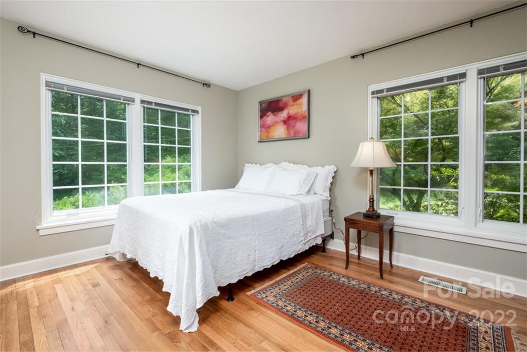 252 Hillbrook Road Tryon, NC 28782 - Photo 35 of 48 a bedroom with a bed and a large window