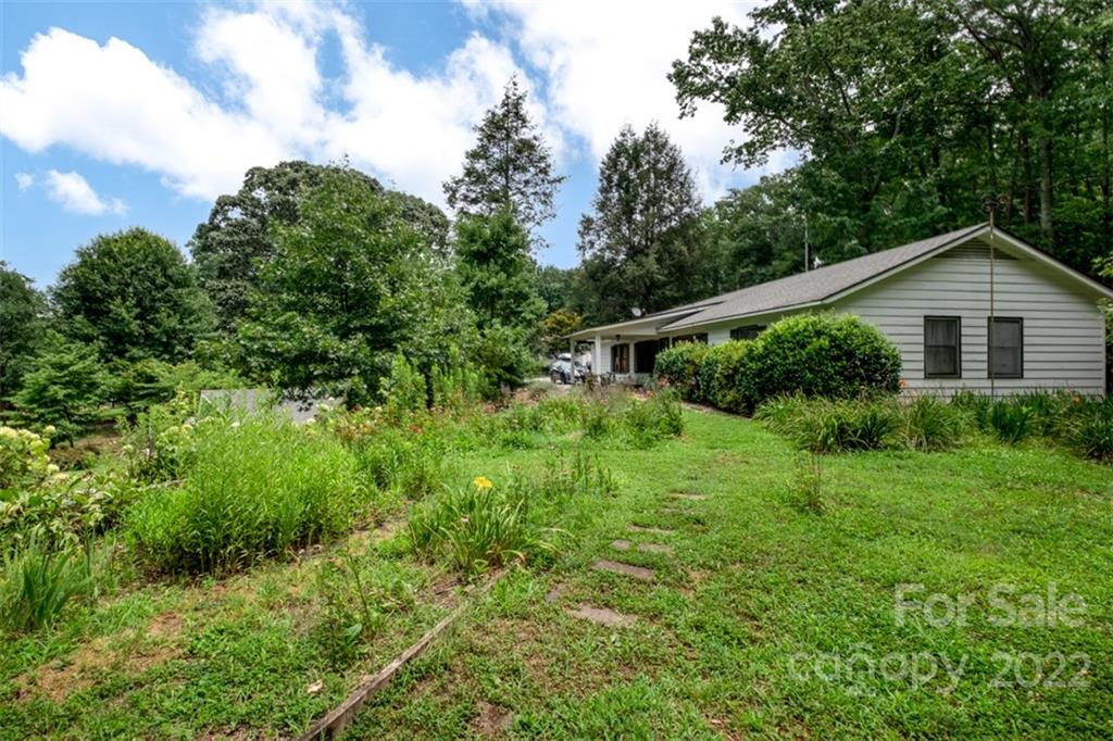 252 Hillbrook Road Tryon, NC 28782 - Photo 44 of 48 a view of a large garden with plants and large trees