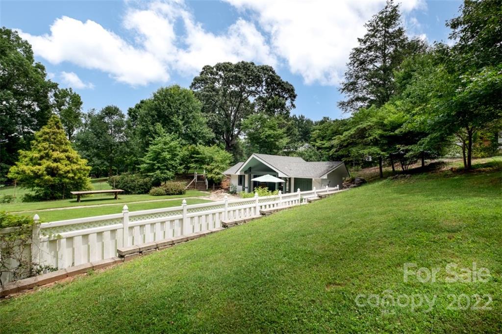 252 Hillbrook Road Tryon, NC 28782 - Photo 45 of 48 a view of an house with a big yard and large trees