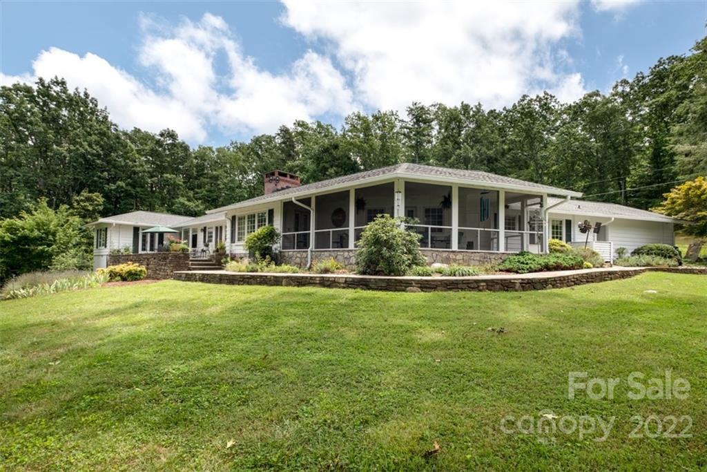 252 Hillbrook Road Tryon, NC 28782 - Photo 5 of 48 a view of a house with a backyard