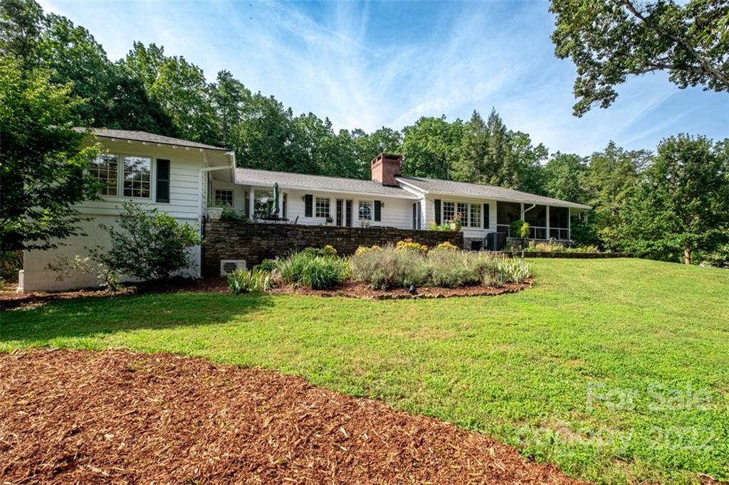 252 Hillbrook Road Tryon, NC 28782 - Photo 6 of 48 a front view of a house with garden