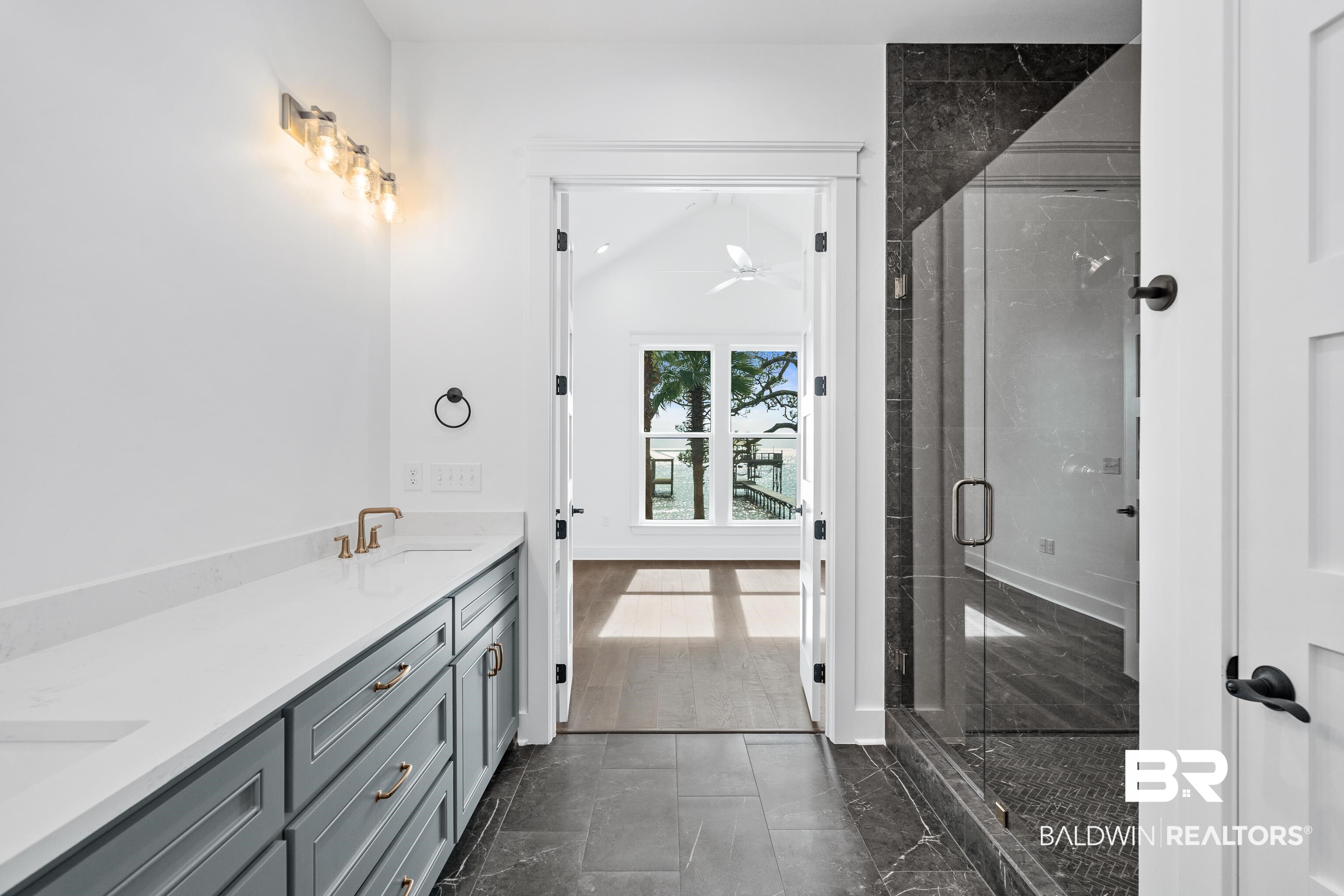 12453 County Road 1 Fairhope, AL 36532 - Photo 16 of 33 Bathroom with hardwood / wood-style floors, vanity, an enclosed shower, and lofted ceiling