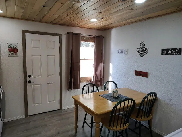 a view of a a dining room with furniture window and wooden floor
