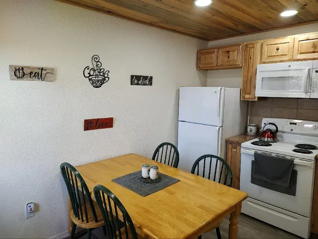 a view of a dining table and chairs