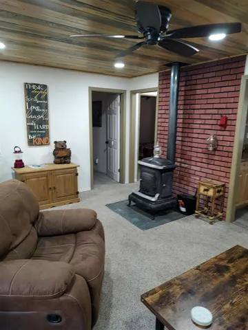a living room with furniture gym equipment and a rug