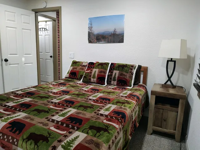 a bedroom with a bed and a mirror