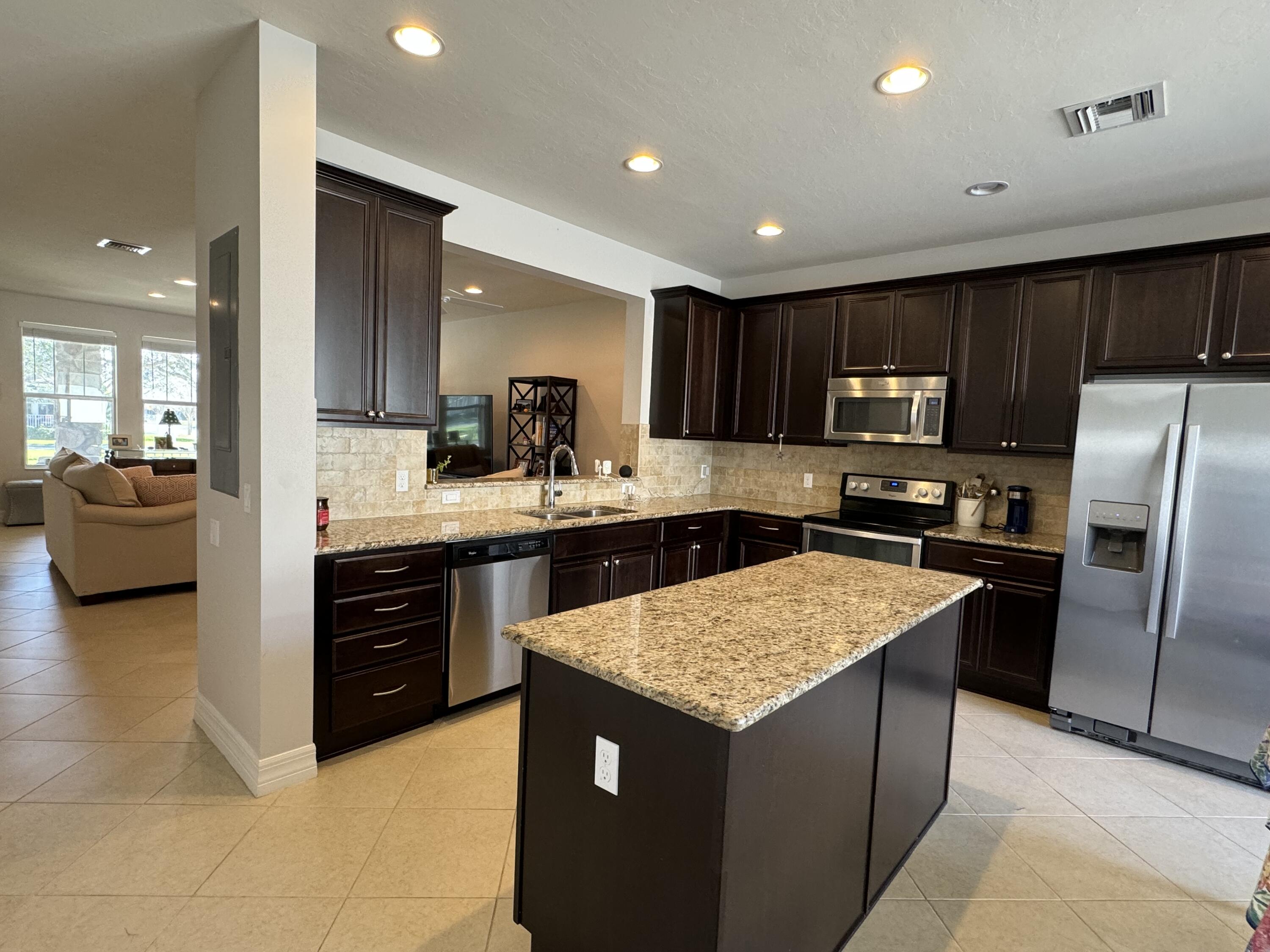 2758 Avalon Way Jupiter, FL 33458 - Photo 16 of 51 a kitchen with a refrigerator a sink a stove a microwave and cabinets