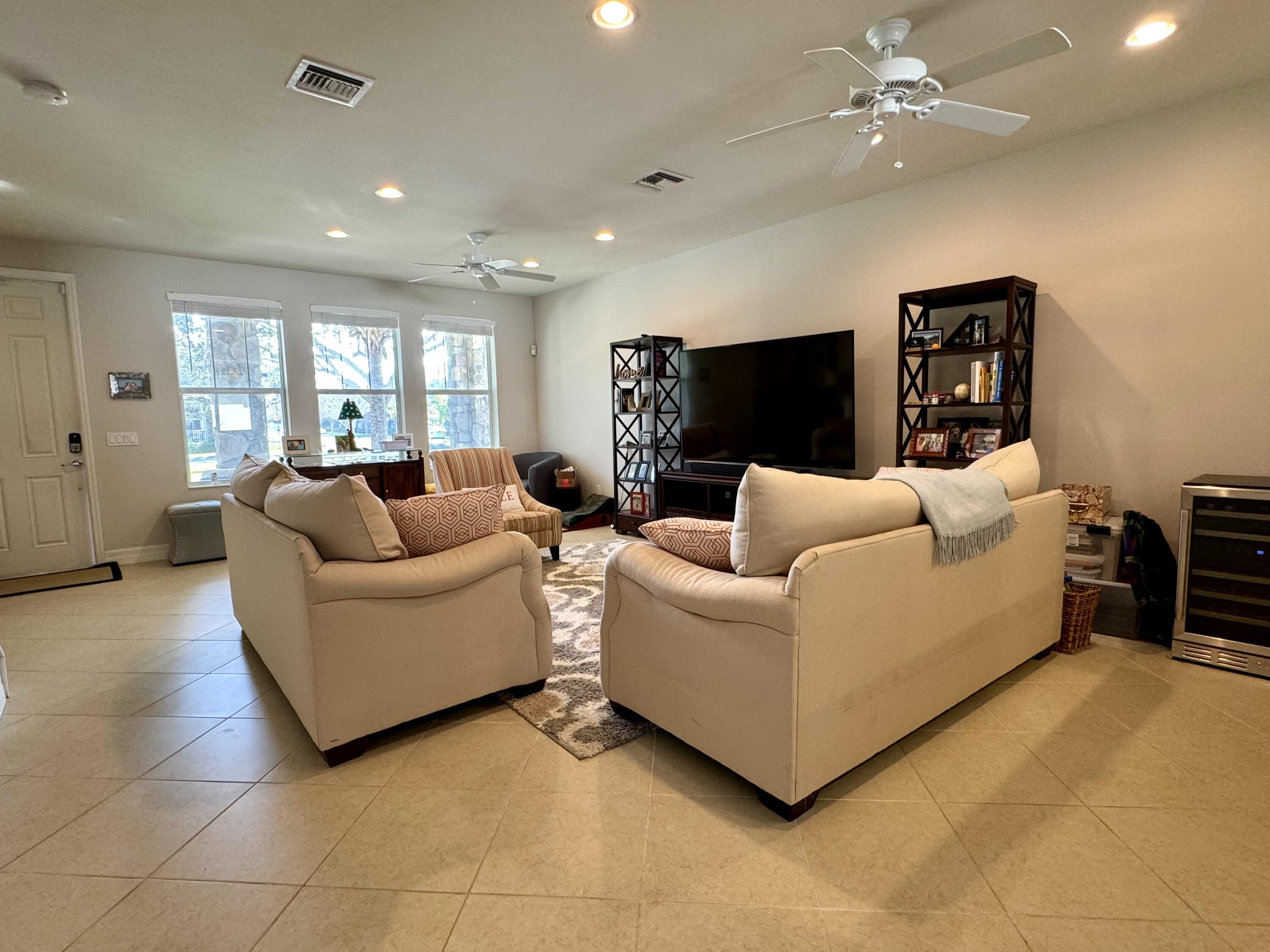 2758 Avalon Way Jupiter, FL 33458 - Photo 17 of 51 a living room with furniture and a flat screen tv