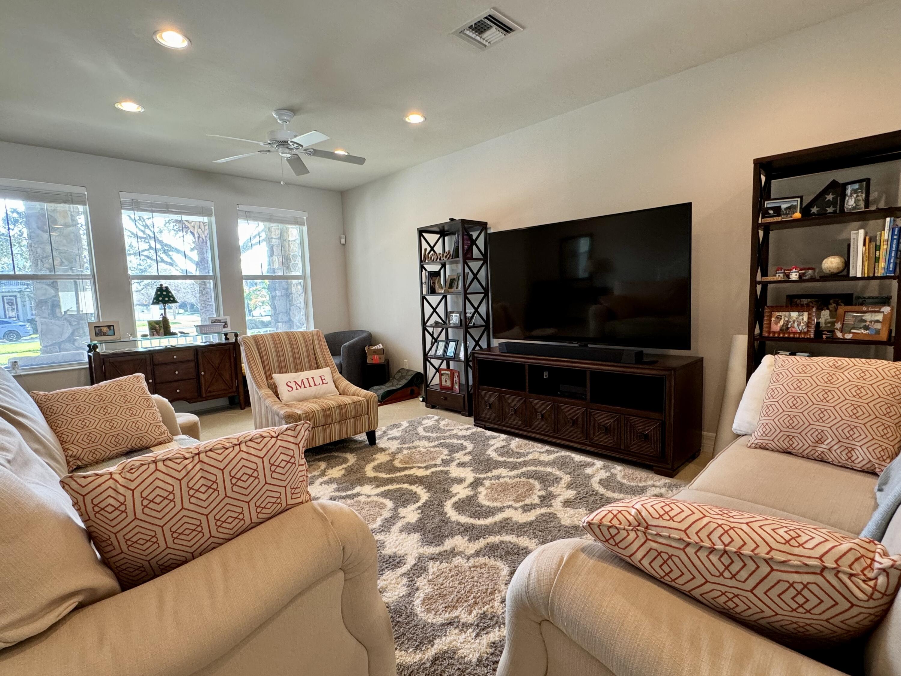 2758 Avalon Way Jupiter, FL 33458 - Photo 18 of 51 a living room with furniture and a flat screen tv
