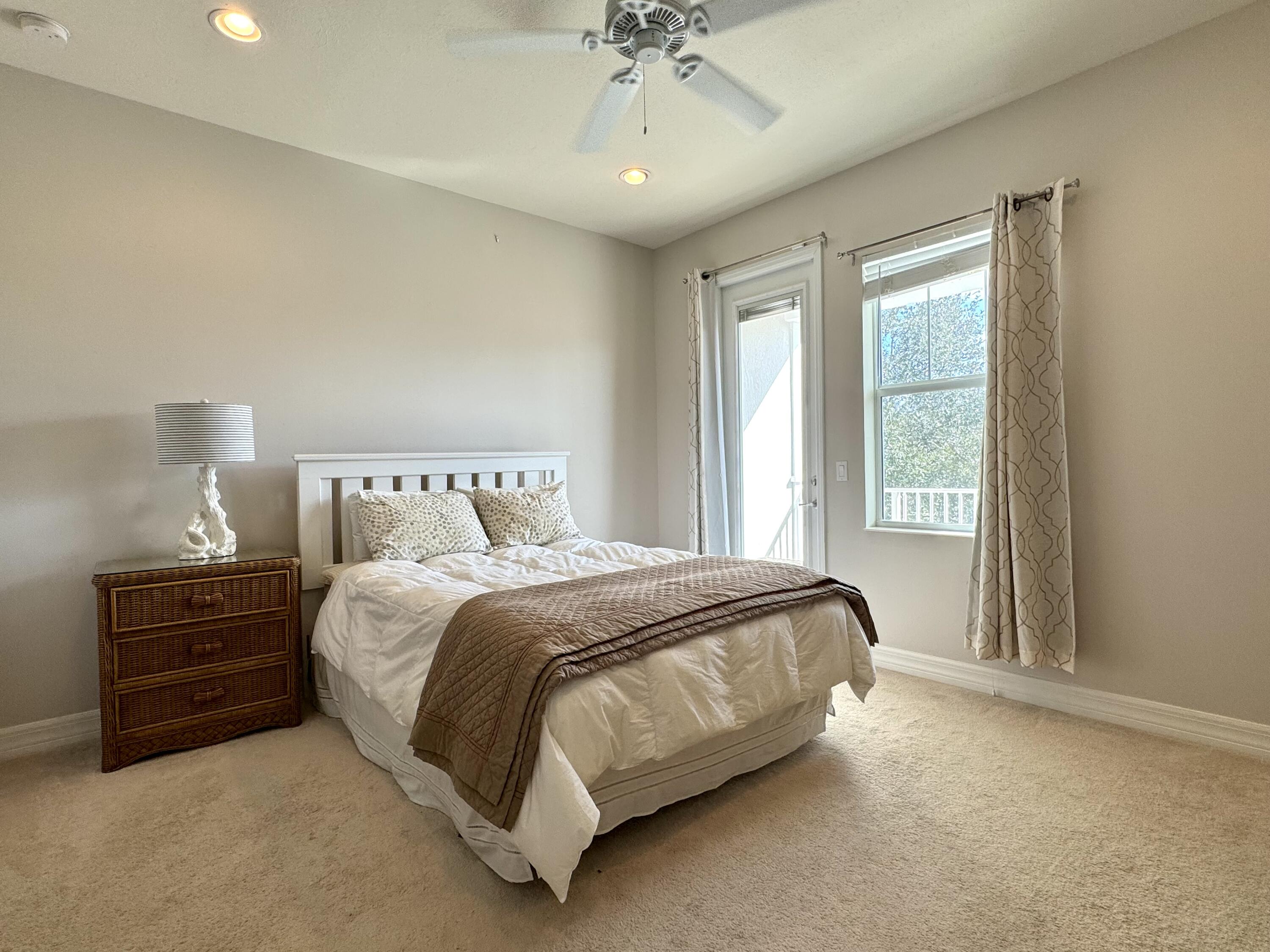 2758 Avalon Way Jupiter, FL 33458 - Photo 21 of 51 a bedroom with a bed and a chandelier