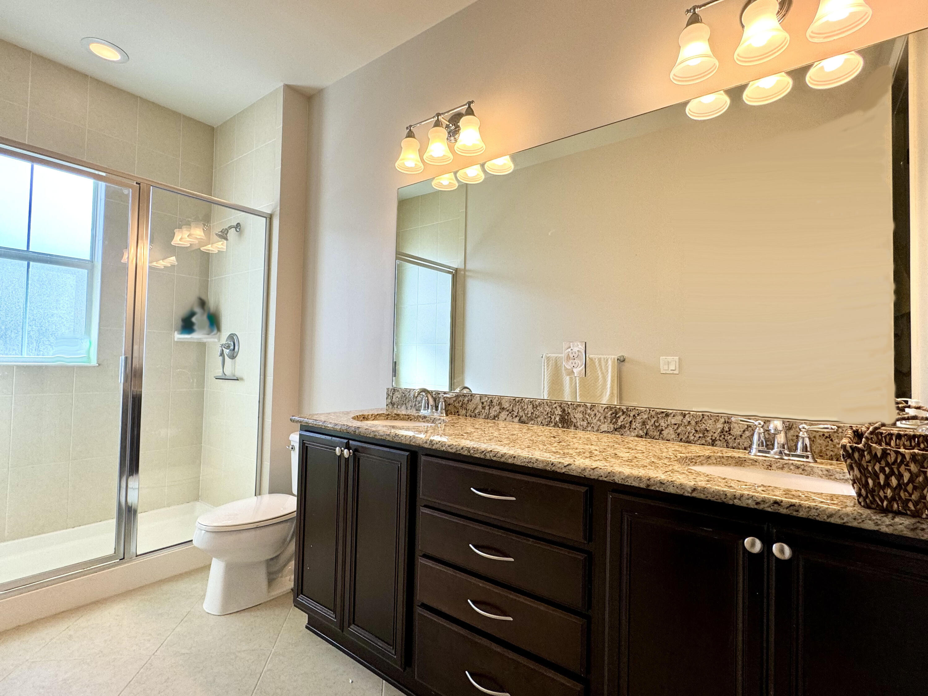 2758 Avalon Way Jupiter, FL 33458 - Photo 22 of 51 a bathroom with a granite countertop sink a toilet and a large mirror