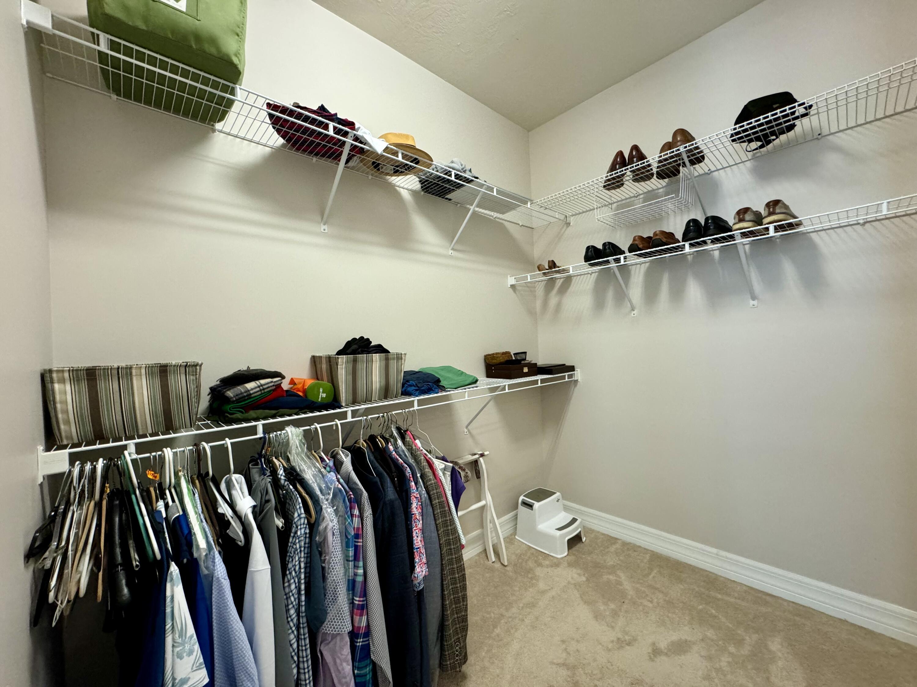 2758 Avalon Way Jupiter, FL 33458 - Photo 25 of 51 a view of walk in closet with clothes and shoes