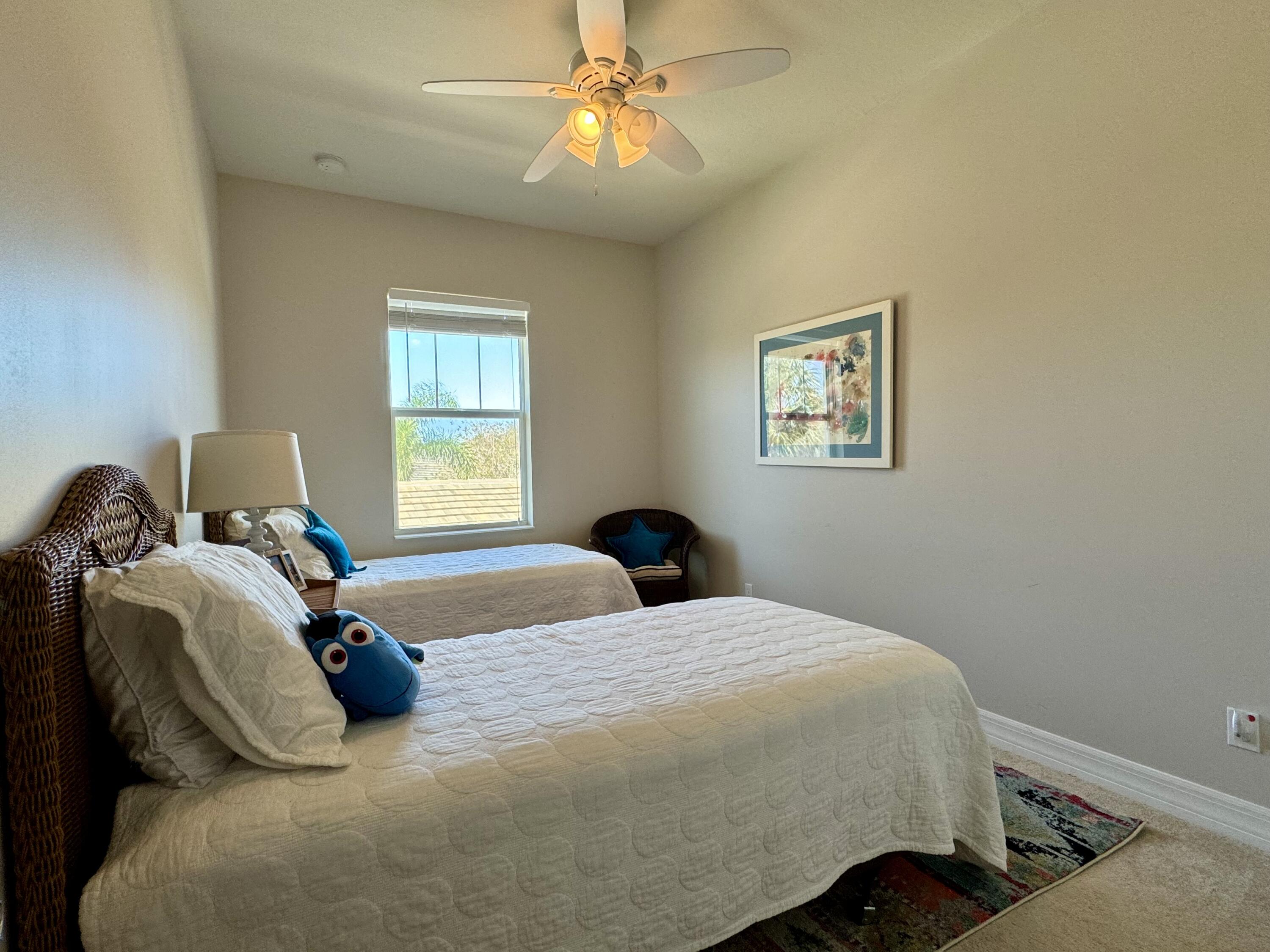 2758 Avalon Way Jupiter, FL 33458 - Photo 27 of 51 a bedroom with a bed and a chandelier