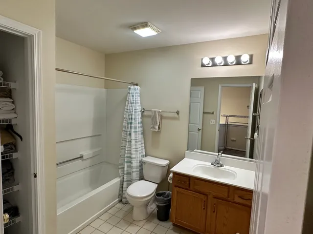a bathroom with a sink toilet a mirror and shower