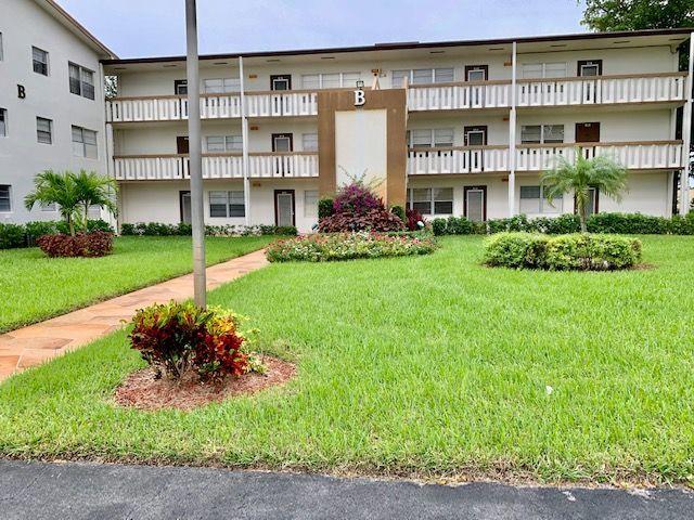 55 Mansfield B, Unit 55 Boca Raton, FL 33434 - Photo 1 of 19 a front view of a building with a garden and plants