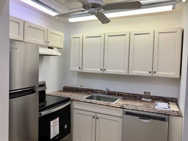 55 Mansfield B, Unit 55 Boca Raton, FL 33434 - Photo 3 of 19 a kitchen with stainless steel appliances granite countertop a refrigerator sink and white cabinets