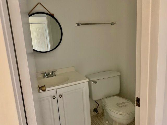 55 Mansfield B, Unit 55 Boca Raton, FL 33434 - Photo 6 of 19 a bathroom with a toilet and a mirror