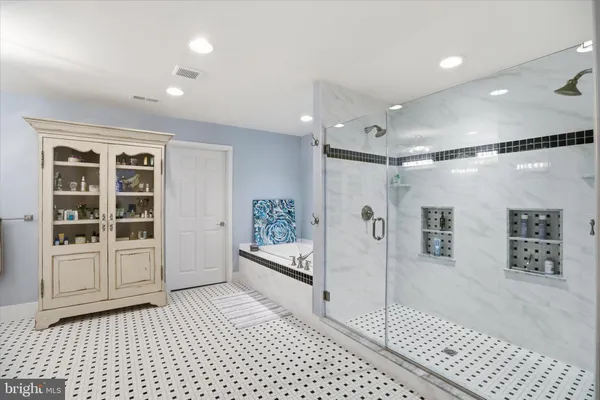 a bed room with a bed and a ceiling fan