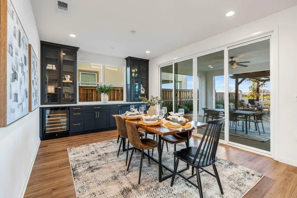a dining room with furniture and wooden floor