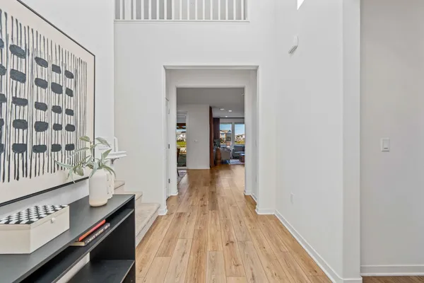 a view of hallway with wooden floor