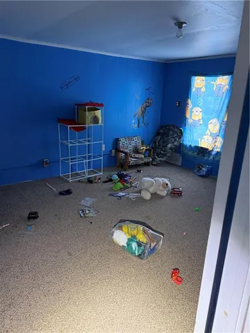 a bedroom with bed and a window