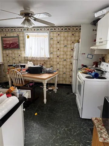 a kitchen with kitchen island granite countertop a sink and a stove