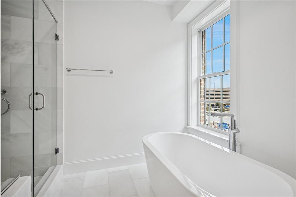 4070 Oak Circle Addison, TX 75001 - Photo 12 of 38 a bathroom with a bathtub and shower