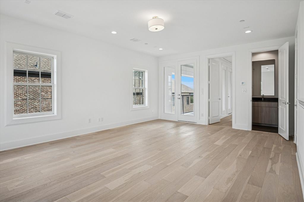 4070 Oak Circle Addison, TX 75001 - Photo 19 of 38 wooden floor in an empty room with a window