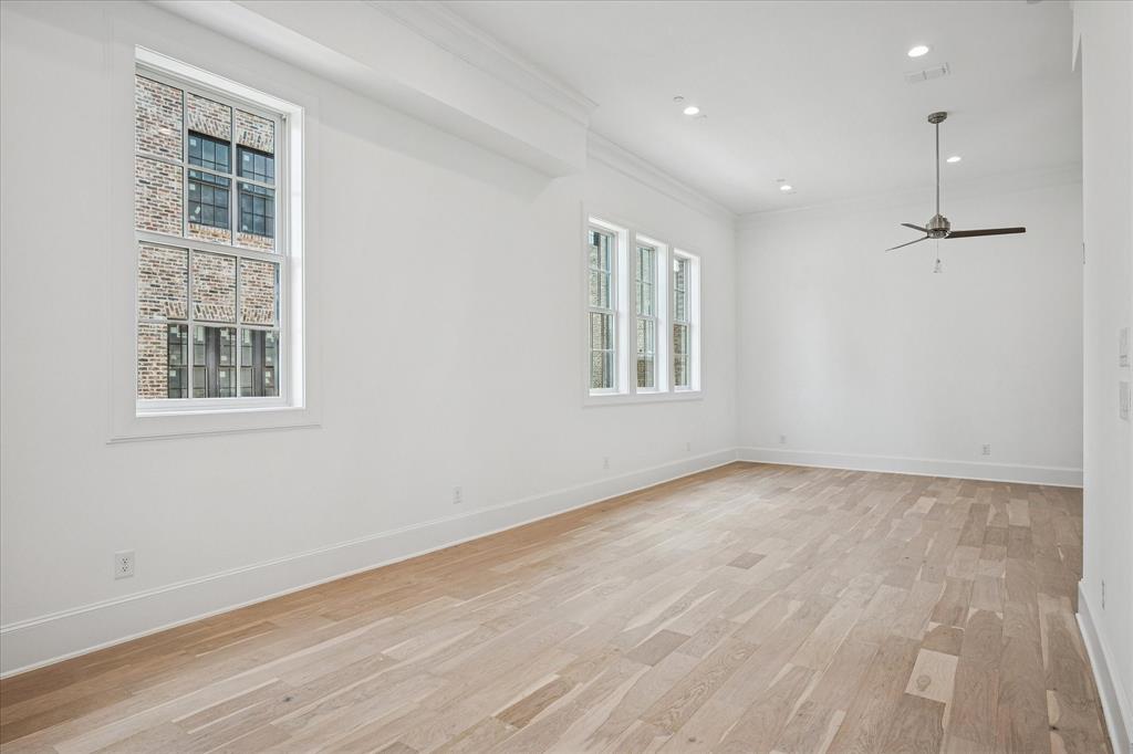 4070 Oak Circle Addison, TX 75001 - Photo 25 of 38 an empty room with wooden floor and windows