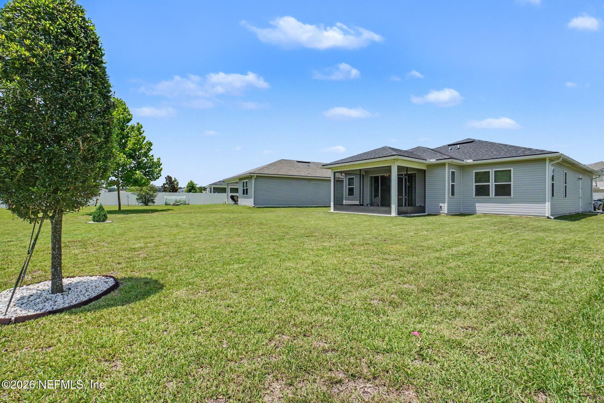 4630 Pine Ridge Parkway Middleburg, FL 32068 - Photo 29 of 35 a view of a house with a yard potted plants and large tree