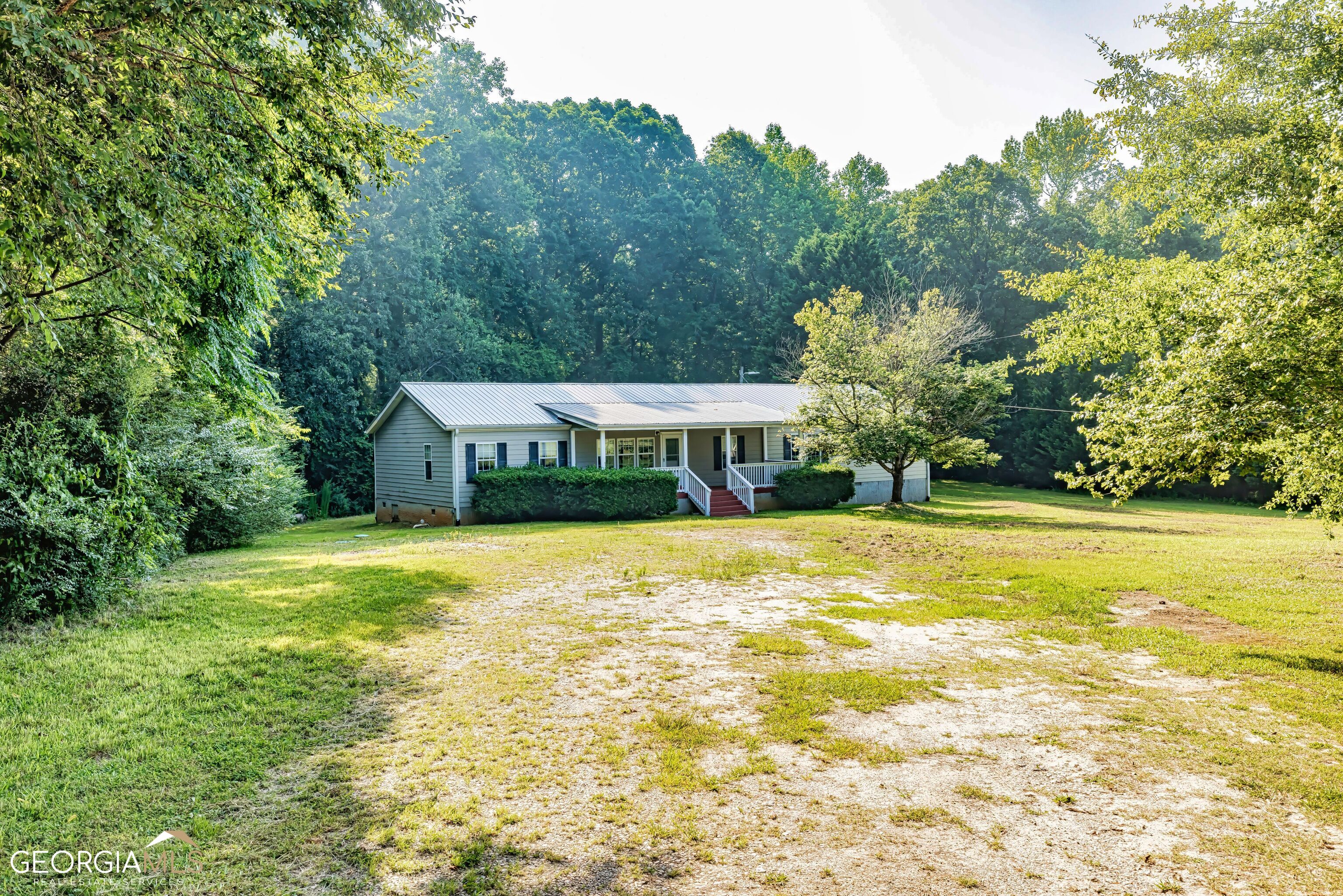 159 Wisso Road Griffin, GA 30223 - Photo 1 of 1 a view of a swimming pool with lawn chairs under an umbrella