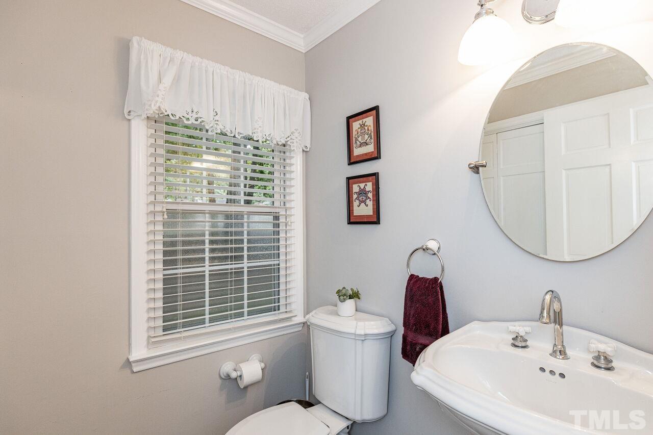 7811 Breckon Way Raleigh, NC 27615 - Photo 15 of 30 a white toilet sitting next to a bathroom sink