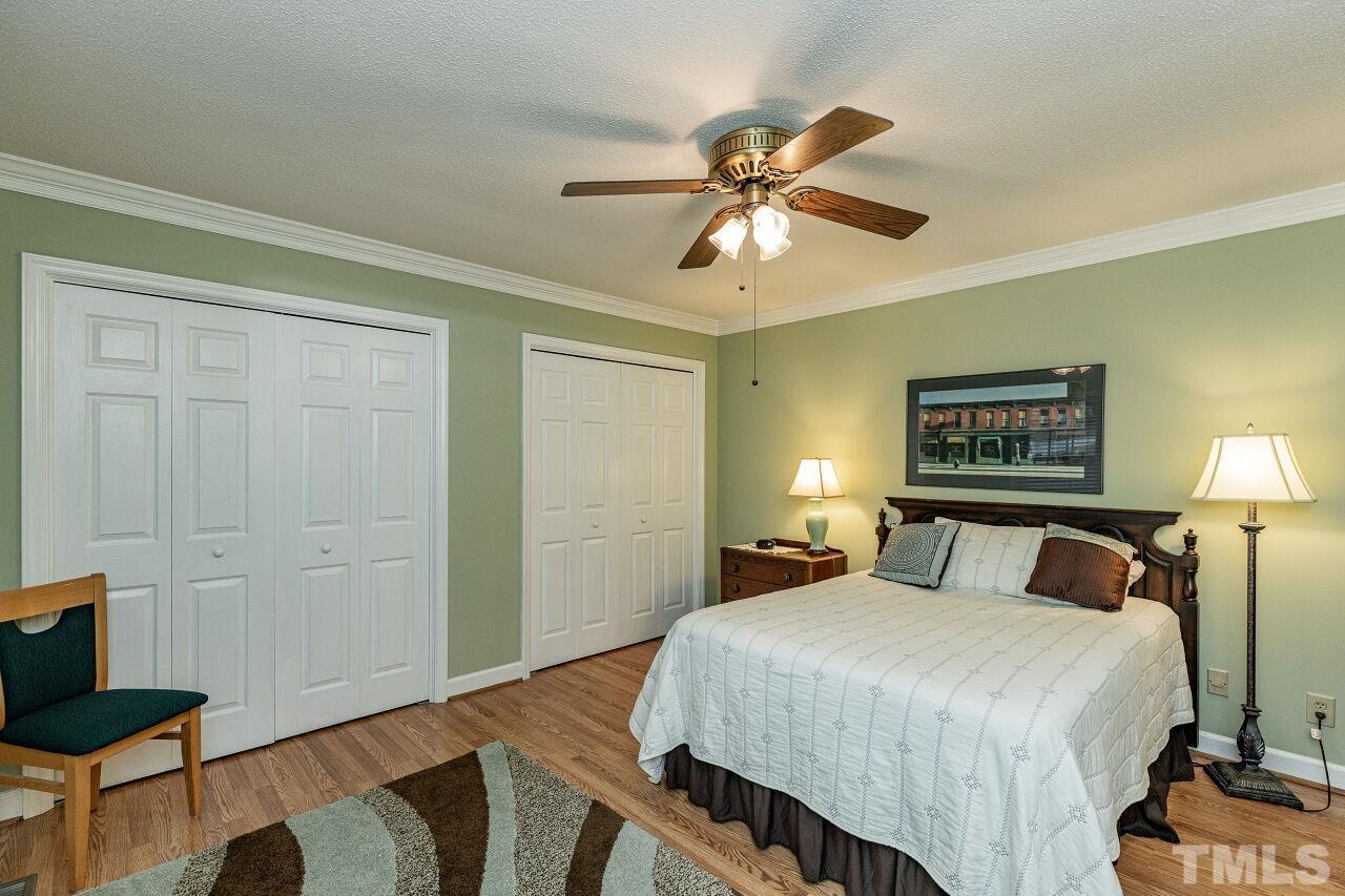 7811 Breckon Way Raleigh, NC 27615 - Photo 17 of 30 a bedroom with a bed and a painting on the wall