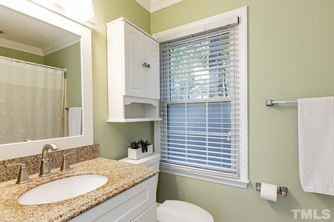 7811 Breckon Way Raleigh, NC 27615 - Photo 20 of 30 a bathroom with a granite countertop sink toilet and mirror